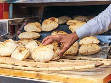Baker Making Fresh Pita Bread Known As Aish In Manshiyat, Naser, Cairo