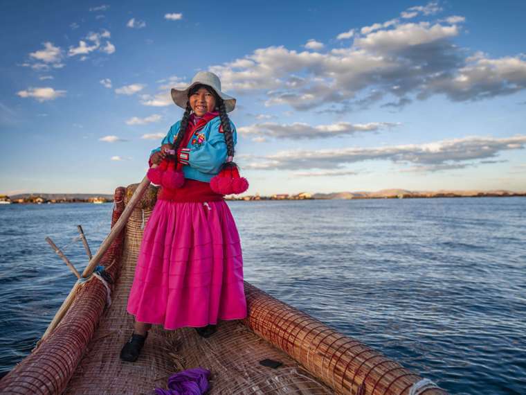 Peruvian Woman Sailing Between Uros Floating Islands, Peru