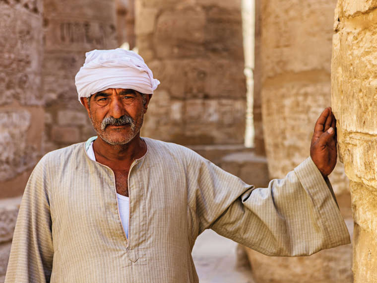 Man leaning on Karnak Temple, Egypt