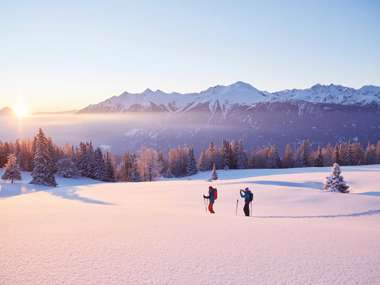 Couple skiing in snow, Schneeschuhwandern Simmering, Austria