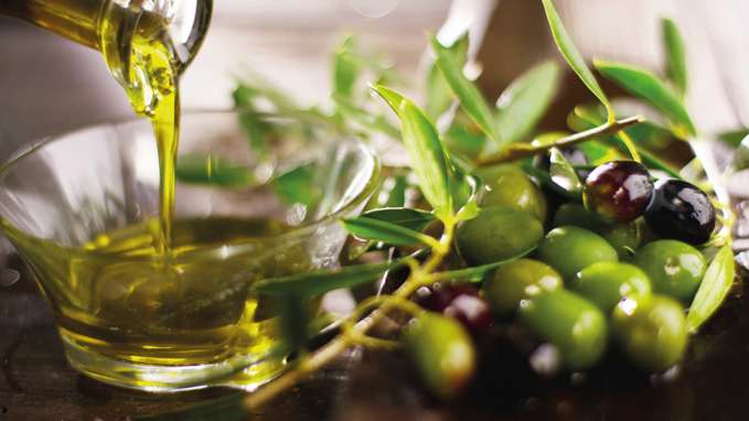 Italian Organic Oil in a bowl next to Olives