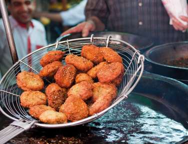 Falafel being lifted out of fryer in Egypt