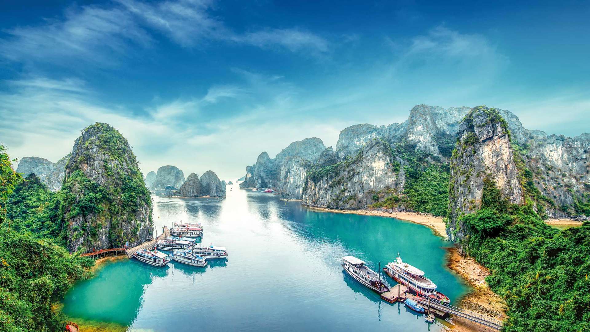 Tourist Junks Floating Among Limestone Rocks At Ha Long Bay, Vietnam