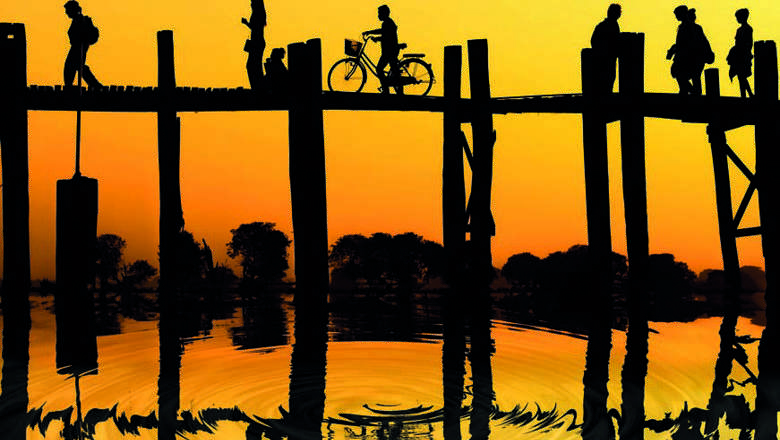 Silhouette Of People Traveling Across The U Bein Bridge In The Evening, Taungthaman, Burma