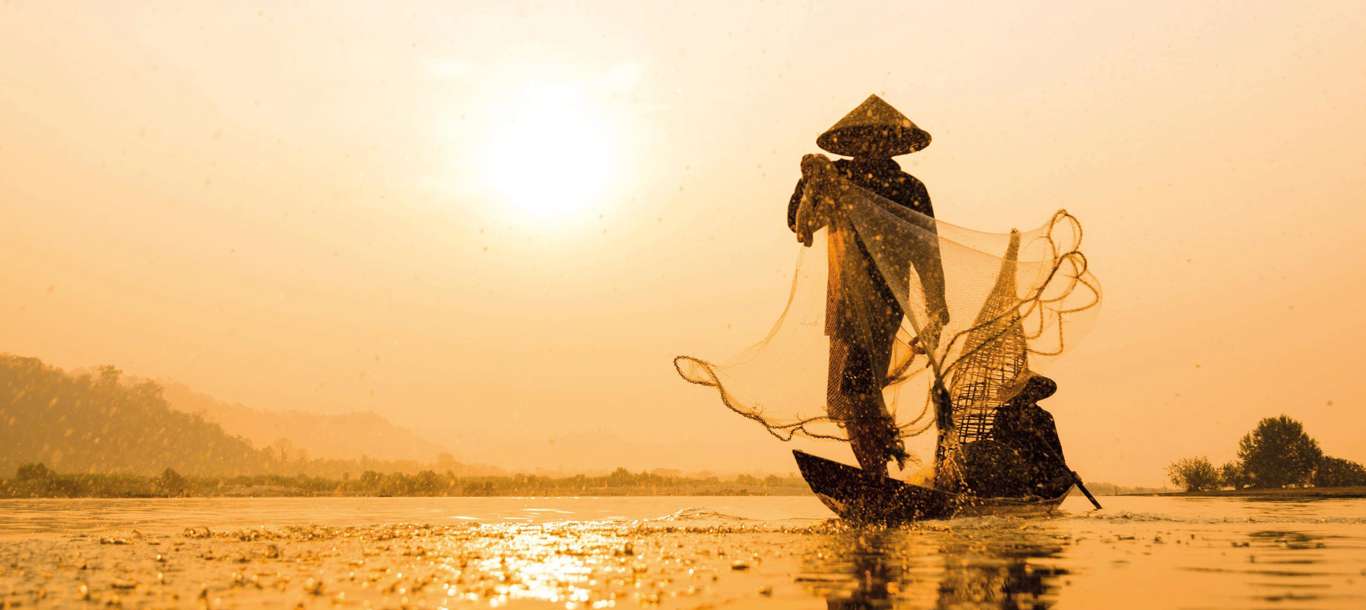 Fisherman Net Casting On The Boat On Morning Time Sunrise, Asia