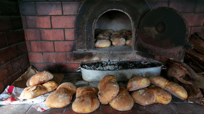 Bread surrounding the oven and coals