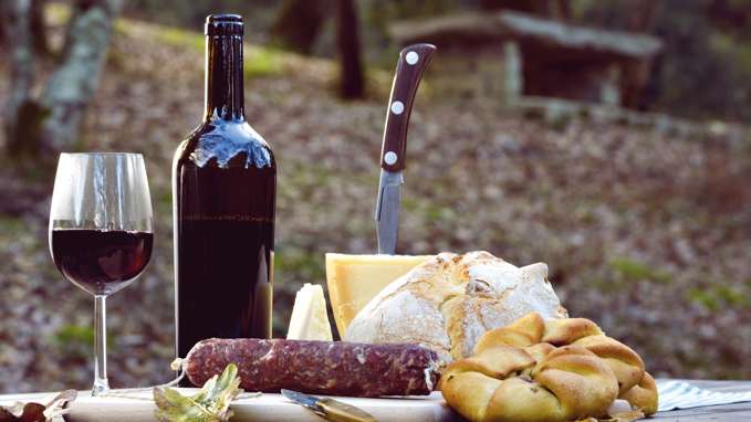 Wine, bread and cured meat on a table